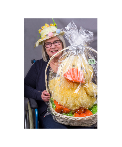 Woman holding a basket with a stuffed animal in it