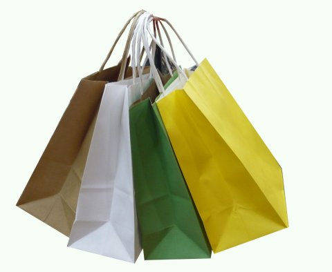 brown, white, green and yellow paper shopping bags