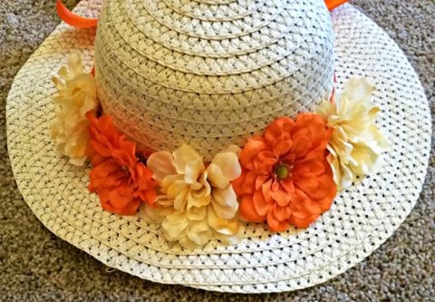 summer like hat with yellow and orange flowers wrapped around it