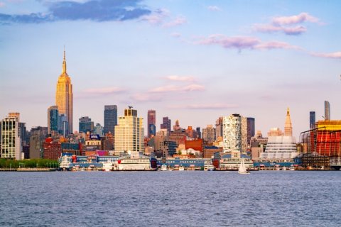 City skyline across body of water during the day time