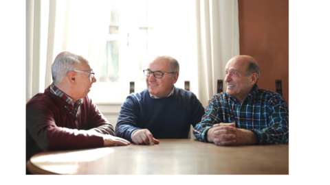3 men talking at a table