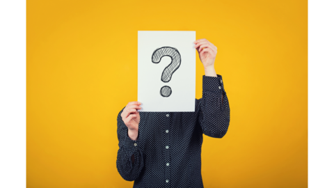 person holding a sign with a question mark