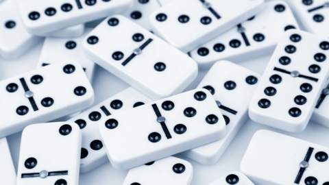 A pile of white tiles with black dots