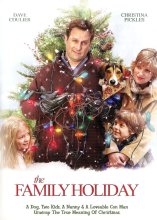 A man wrapped in Christmas lights with a dog, children and a women looking up at him 