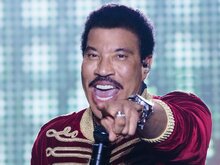 Photo of Lionel Richie pointing at the camera and singing